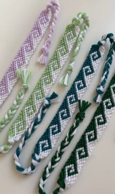 four bracelets with different colors and designs on them