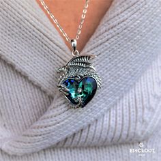 The dragon is a powerful symbol that has been revered for centuries in many cultures. It represents strength, courage, and protection. This beautiful blue crystal heart necklace is the perfect way to show your inner strength and remind you of the powerful, protective energy that all of us have inside. Whether you're dressing up or just want to add a little bit of magic to your everyday look, this necklace is sure to inspire your confidence and make you feel beautiful every time you wear it. Trea Sterling Silver Spiritual Necklace With Dragon Design, Mystical Blue Sterling Silver Necklace, Spiritual Sterling Silver Necklace With Dragon Design, Blue Fantasy Jewelry For Gifts, Blue Fantasy Jewelry For Gift, Blue Crystals Stones, Crystal Heart Necklace, Dragon Necklace, Silver Dragon