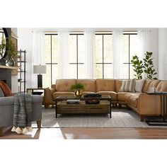 a living room with two couches and a coffee table in front of large windows