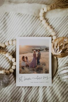 a family photo on a bed with beaded bracelets and beads around the frame