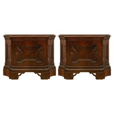 a pair of wooden nightstands with carvings on the sides