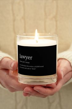 a person holding a candle in their hands with the words lawyer printed on it