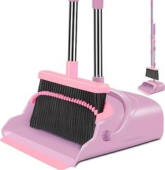 a pink and black dustpan with two brooms