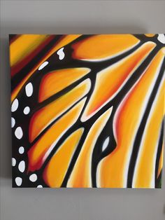 a painting of a butterfly wing with white dots on it's wings and an orange background