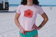 Are you craving that 2000s and 90s nostalgia? We've got you covered with this adorable Hibiscus Flower Baby Tee - bringing your Y2K outfit dreams to life! Our adorable Y2K baby tees will become your new favorite Coconut girl / Mermaidcore shirt from the first wear!  ABOUT THE TEE: - 100% USA cotton (Please note: The Sports Gray variation includes 90% Cotton & 10% Polyester for that authentic touch) - Ribbed knit crew neckline and a convenient tear-away label - Embrace that 90s style with a fit r Pink Cotton Short Sleeve Hawaiian Shirt, Pink Hibiscus Print T-shirt For Summer, Pink Floral Print Y2k Tops, Pink Y2k Style Beach Top, Y2k Pink Top For Beach, Fitted Cotton T-shirt For Beach, Y2k Summer T-shirt For Beach, Fitted Tropical Cotton Tops, Y2k Style Tops For Beach Vacation