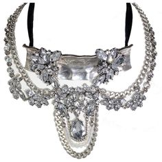 Choker style necklace with antique design and crystal rhinestone embellishments. Silver Jeweled Metal Bib Necklaces, Silver Jeweled Bib Necklaces, Silver Crystal Choker With Jewels, Silver Crystal Bib Necklaces Costume Jewelry, Silver Crystal Bib Necklace Costume Jewelry, Rhinestone Jeweled Choker Necklace, Silver Crystal Costume Bib Necklaces, Rhinestone Jewel Choker Necklace, Silver Crystal Choker With Chain