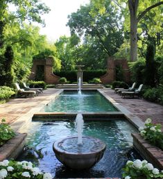 an outdoor fountain in the middle of a garden