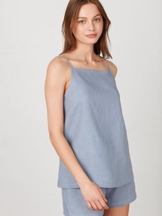 "AMBER is a simple linen strap top with a square neckline. DETAILS - Sleeveless design - Spaghetti straps - Square neckline - Oeko-Tex certified 100% local washed midweight linen - Cut and sewn to order just for you in our studio COLOR - Vista Blue, you can also choose other colors above - Fabric samples are available here https://www.etsy.com/listing/586569696/linen-fabric-samples SIZING & FIT - True to size - Model is 5'10\" / 178cm and wearing a size XS CARE FOR LINEN - Machine wash up to 30ºC/86ºF gentle cycle - Lay flat to dry or tumble dry low - Warm iron if needed - Do not bleach SIZE GUIDE Size conversion guide Size XS (US 0-2, IT 36-38, UK 4-6, Japan 3-5, France 32-34) Size S (US 4-6, IT 40-42, UK 8-10, Japan 7-9, France 36-38) Size M (US 8-10, IT 44-46, UK 12-14, Japan 11-13, Fra Summer Square Neck Top With Tie Straps, Summer Cotton Tank Top With Square Neck, Square Neck Cotton Tank Top For Summer, Summer Square Neck Top With Adjustable Straps, Summer Linen Top With Tie Straps, Summer Cotton Tops With Straight Neckline, Summer Tops With Adjustable Straps And Straight Neckline, Summer Linen Tank Top With Adjustable Straps, Summer Square Neck Camisole With Adjustable Straps