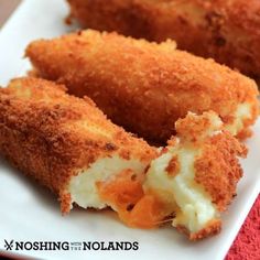 two pieces of fried food on a white plate with the words noshing in hollands