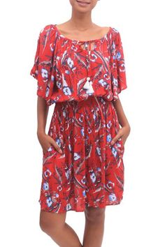 Displaying lovely floral motifs printed over a body of strawberry red this tunic-style dress is designed by Bali's Ratu and Devi. Crafted from rayon this lovely dress features a tie closure on the front with short sleeves an empire waist and a knee-length skirt. Spring Red Printed Dresses, Red Floral Casual Summer Dress, Red Casual Floral Summer Dress, Casual Red Floral Summer Dress, Casual Red Printed Mini Dress, Red Printed Floral Dress For Spring, Floral Print Short Sleeve Rayon Dress, Floral Print Rayon Dress With Short Sleeves, Short Sleeve Floral Print Rayon Dresses