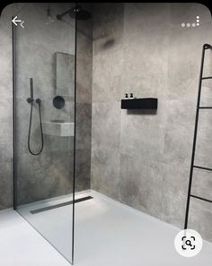 a bathroom with grey walls and white flooring has a ladder to the shower area