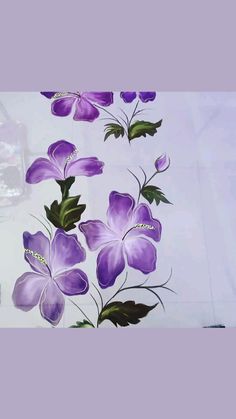 purple flowers painted on the side of a wall