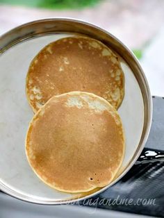 two pancakes sitting on top of a white plate