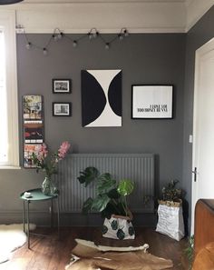 a living room filled with furniture and pictures on the wall next to a radiator