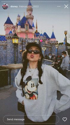 a woman standing in front of a castle