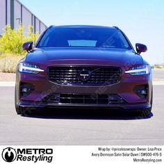 the front end of a purple car parked in a parking lot