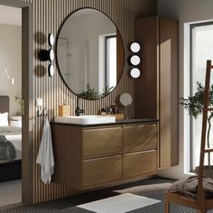 a bathroom with a sink, mirror and chair