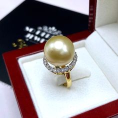 A lustrous pearl, cocktail ring is a need for every lady in the world. What could get you more attention than having this huge, exotic, and sparkling pearl ring on your finger while holding a glass of wine? We are presenting you with a Huge GOLDEN SOUTH SEA PEARL, absolutely natural color and TOP AA+ luster, 14 mm in size, surrounded by 22 pieces of hand-set F/VS superb quality diamonds, weighting at 0.64 carat. Set in handcrafted, one of a kind 18K solid white gold ring, weighting at 8.0 grams. Luxury Pearl Diamond Ring As Gift, Elegant Pear-shaped Diamond Ring Gift, Diamond Pearl Ring With High Luster For Gift, Gift Pearl Ring With High Luster And Diamond, Golden South Sea Pearls, Sea Pearl, Sea Pearls, South Sea Pearls, White Gold Engagement Rings