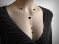 A classic "Y" necklace, or lariat necklace, with Genuine Black Onyx Heart and beads, finished in 14K yellow gold filled.  16 inches in length with the drop measuring an additional 3.5 inches.  Or if you like, specify an exact length(s).  Also available in solid sterling silver.  A 14mm black heart bead at the center, with four 6mm beads.   Ships in 2 to 3 business days. Black Lariat Necklace As Gift, Black Lariat Necklace For Gift, Elegant Black Lariat Necklace With Adjustable Chain, Black Lariat Necklace With Adjustable Chain As Gift, Black Lariat Jewelry For Gift, Gemstone Lariat Necklace, Black Heart Necklace, Casual Couture, Y Necklace