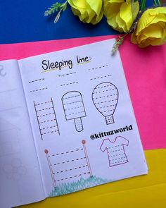 an open book with drawings on it next to yellow flowers and pink paper that says sleeping line