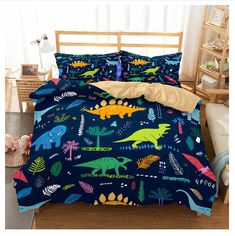 a bed with dinosaurs and plants on it