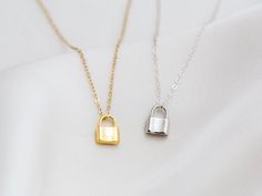 "Dainty lock necklace! The pendant is made of gold vermeil, which is heavy gold plating over sterling silver. Pair it with your favorite outfit! Layer with other necklaces, by or wear itself for a pop! . . . . . . . . . . . . . . . . . . . . . . . . . . . . . . . . . . . . . . . . . . NECKLACE + Length: 16\" + 2\" extender + Vermeil (18k gold plating over sterling silver) -or- sterling silver lock pendant: 8mm x 11mm + 14k gold filled -or- sterling silver chain, spring clasp, & findings LAYE Silver Lock Necklace Gift, Silver Necklace With Lock Gift, Silver Chain Necklace With Lock For Gifting, Silver Lock Chain Necklace As A Gift, Silver Chain Necklace With Lock For Gift, Silver Necklace With Lock As Gift, Everyday Gold Lock Jewelry, Everyday Gold Jewelry With Lock Detail, Gold Chain Necklace With Lock For Gift