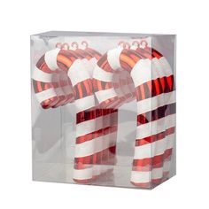 two red and white striped candy canes in a clear box on a white background