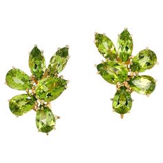 Olive-green radiance of peridot is presented in these earrings. A single pear cut of the gem is orbited halfway by illuminating two marquise and three pears. Marquise cuts accentuate both the depth and weight of the gem, while the pear cuts lift sparkle at the base. Known as the ‘evening emerald’, peridot remains striking in its color and glow under the starlight. The total weight of the peridots is 16.69 carats. 18k yellow gold sets each peridot, while providing a coordinating color. Clip-backs Peridot Jewelry, Peridot Earrings, Turtle Earrings, Earrings Clip, Yellow Gold Setting, Chanel Vintage, Unique Jewelry Designs, Emerald Earrings, Vintage Clip