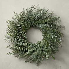 a wreath made out of green leaves on a wall