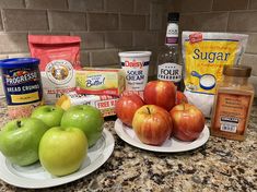 apples, yogurt, and other ingredients are on the counter