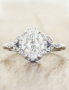 an oval diamond engagement ring with two side stones