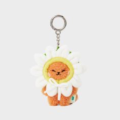 a small stuffed animal with a flower on it's head is hanging from a keychain