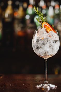 a glass filled with ice and an orange slice