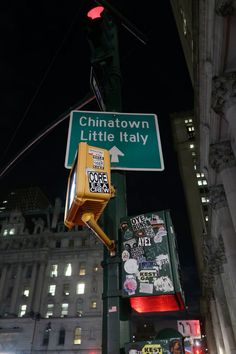 a traffic light and street sign in the city at night