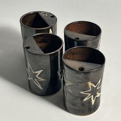 three black and white vases sitting next to each other