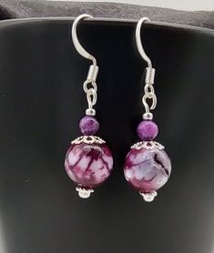 These purple and silver earrings are  a pretty , lightweight  accessory that you can wear with your every day attire . They would also make a great gift! Earring measures approximately 2 inches long. Ready to ship.  Attention! Colors may look different depending on your monitor settings.  Jewelry Care:  To keep the materials in your jewelry in good condition, do not wear while swimming, bathing, or heavily exercising. Avoid contact with abrasive or sharp objects, water, oils, lotions, perfume, chemicals, and excessive perspiration, as these things may alter bead finishes or cause damage to the materials in your jewelry. Purple Beaded Dangle Earrings, Purple Dangle Beaded Earrings, Purple Round Pierced Earrings, Elegant Lavender Beaded Earrings, Purple Nickel-free Earrings For Gift, Nickel-free Purple Earrings As Gift, Purple Ear Wire Earrings For Gift, Purple Ear Wire Earrings As Gift, Purple Dangle Earrings With Ear Wire