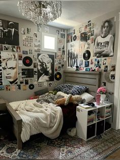 a bed room with a neatly made bed and lots of pictures on the wall