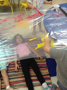 two children are playing with plastic toys on the floor