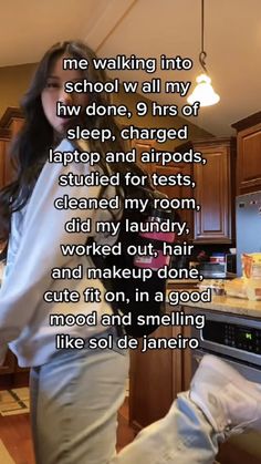 a woman standing in a kitchen next to a stove top oven