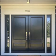 a black front door with two sidelights