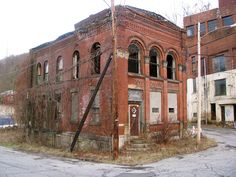 an old run down building with broken windows