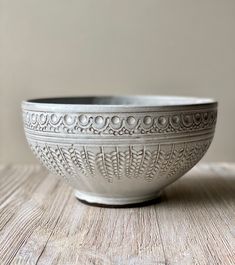 a white bowl sitting on top of a wooden table