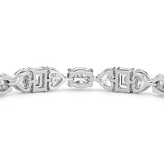 An exceptionally beautiful piece of jewelry infused with sentimentality. This tennis bracelet presents a dazzling pattern of oval, heart, and emerald-cut diamonds. It features emerald-cut diamonds set in between charming heart-shaped diamonds. Emerald-cut diamonds add a nostalgic flair to this piece. Marquise Diamond Accent Bracelets For Anniversary, Diamond Oval Link Bracelets For Anniversary, White Gold Oval Link Bracelet For Anniversary, Oval Link Gemstone Bracelets For Anniversary, White Gold Heart Cut Bracelet Fine Jewelry, Marquise Diamond Bracelet In White Gold As A Gift, Timeless Oval Link Bracelet For Anniversary, Emerald Cut Diamond Accented Bracelets As Gifts, Emerald Cut Diamond Bracelet In White Gold As Gift