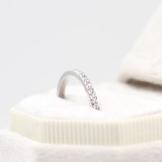 a diamond ring sits on top of a white towel