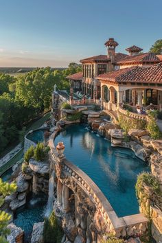 an aerial view of a house with a swimming pool and waterfall in the foreground