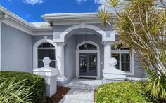 the front entrance to a house with white trim