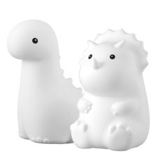 two white plastic animals sitting next to each other