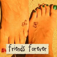 two people with matching tattoos on their feet and one has a sign that says friends forever