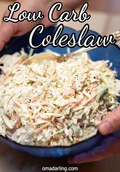 two hands holding a bowl of coleslaw with the words low carb coleslaw