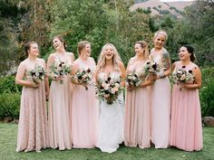 a group of women standing next to each other holding bouquets